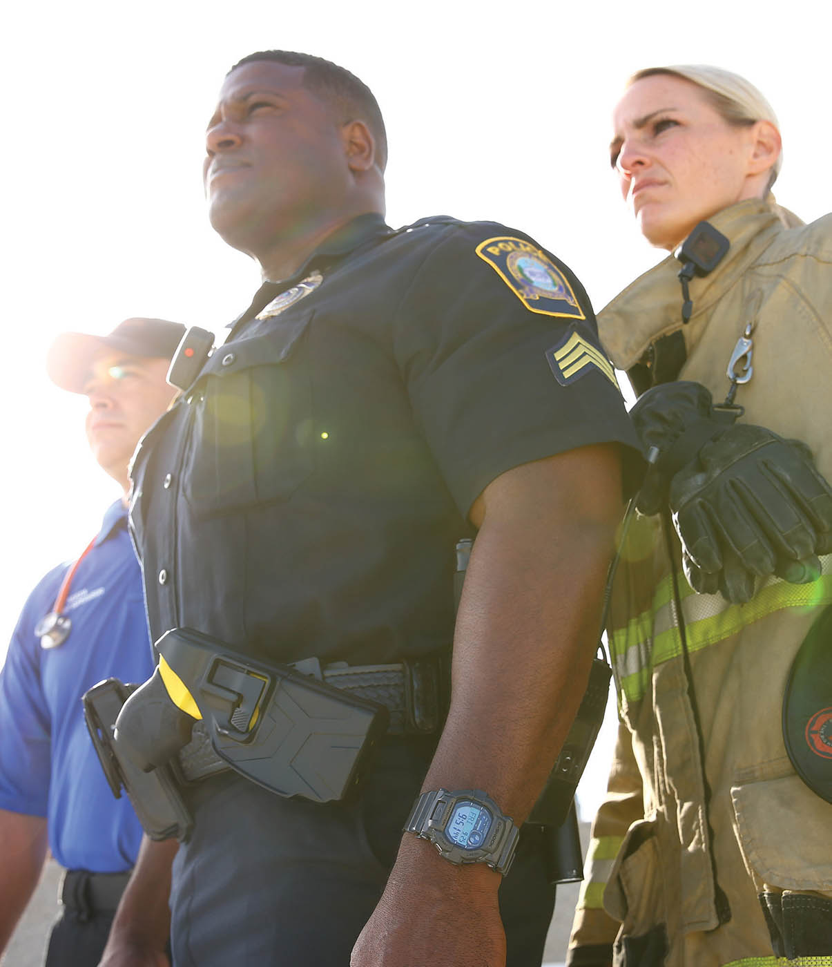 Police officer, firefighter, and paramedic standing together